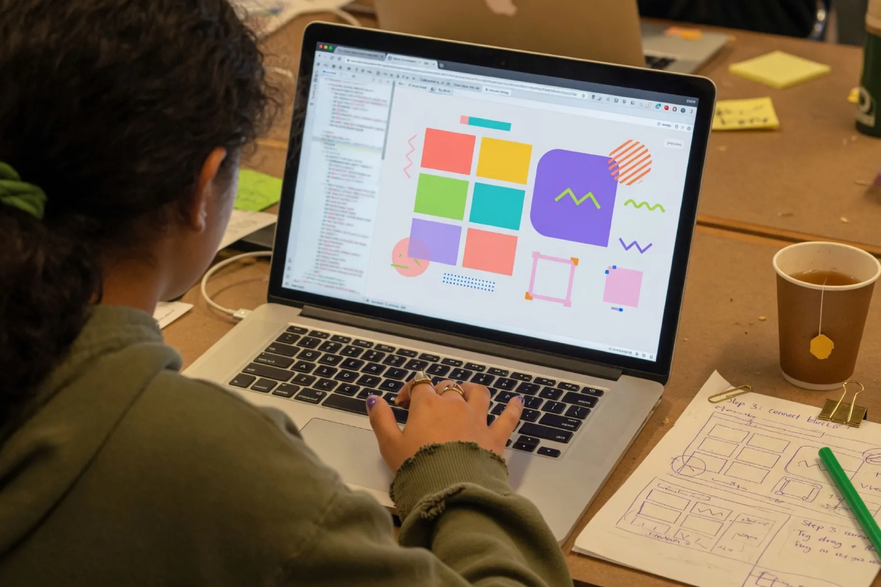 A student building a simple app on a laptop during a teen AI class